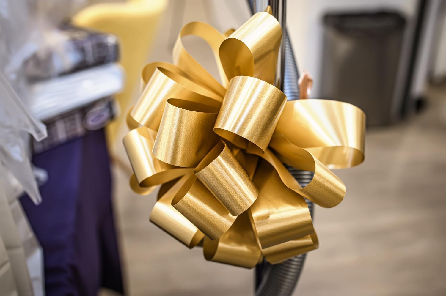 Gold metallic ribbon enhancing branded product packaging