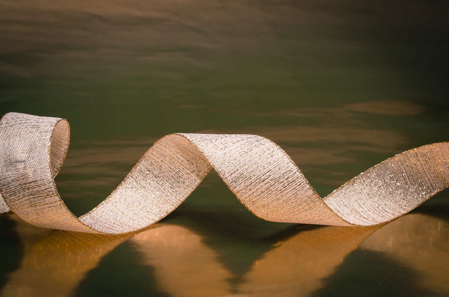 Gold metallic ribbon enhancing branded product packaging